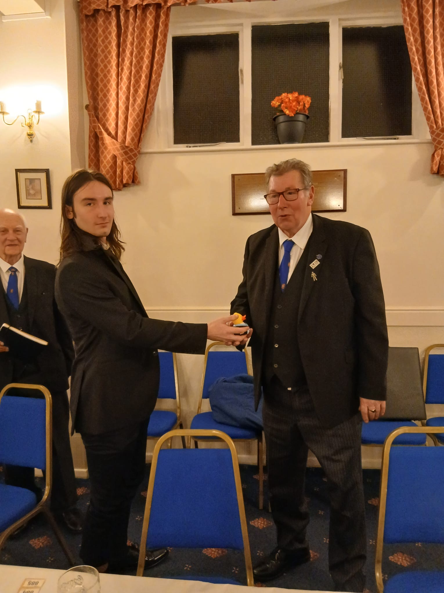 Bro. Freitag presenting the Travelling Duck to W. Bro Peter Coates